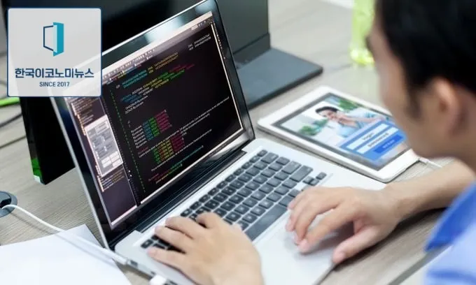 A software developer works on his laptop. Photo by Shutterstock/ProStockStudio